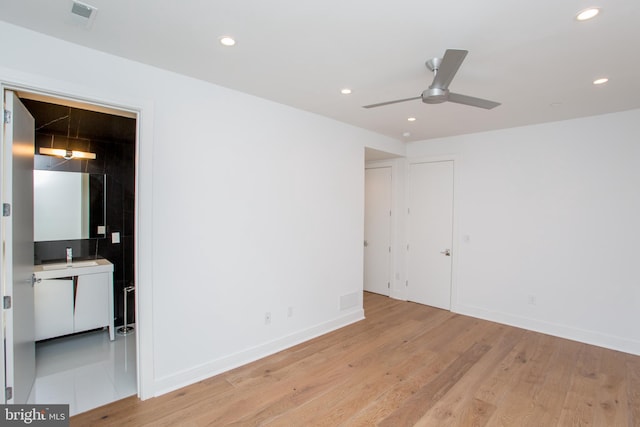 spare room with ceiling fan and light hardwood / wood-style flooring