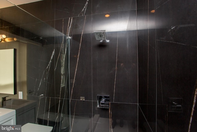 bathroom featuring walk in shower, vanity, and toilet