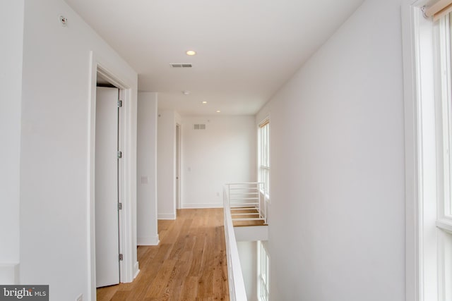 hallway with light hardwood / wood-style floors