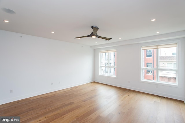 unfurnished room with ceiling fan and light hardwood / wood-style floors