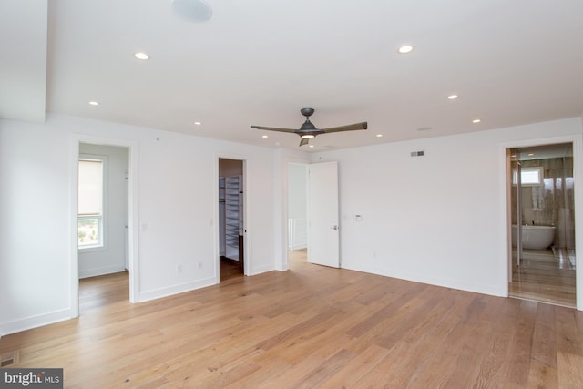 empty room with light wood-type flooring and ceiling fan