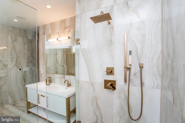 bathroom with tile walls, a tile shower, and vanity