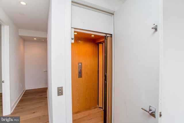 hall featuring light hardwood / wood-style floors and elevator