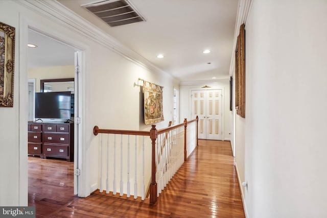 corridor featuring ornamental molding and hardwood / wood-style floors