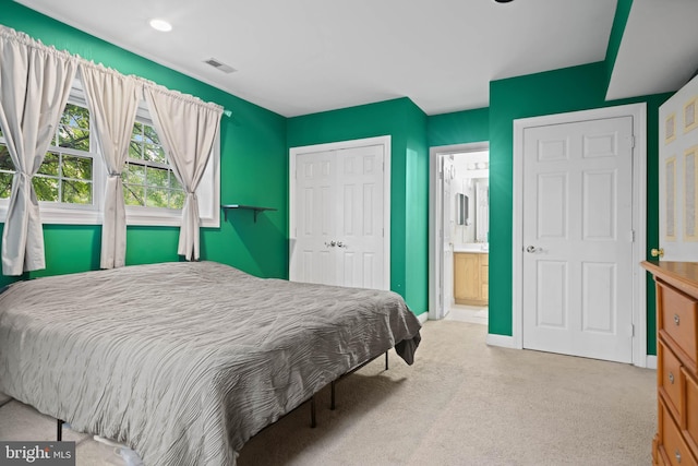 carpeted bedroom featuring connected bathroom