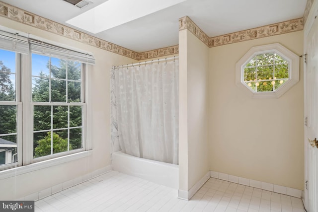 bathroom featuring tile patterned flooring and shower / bathtub combination with curtain