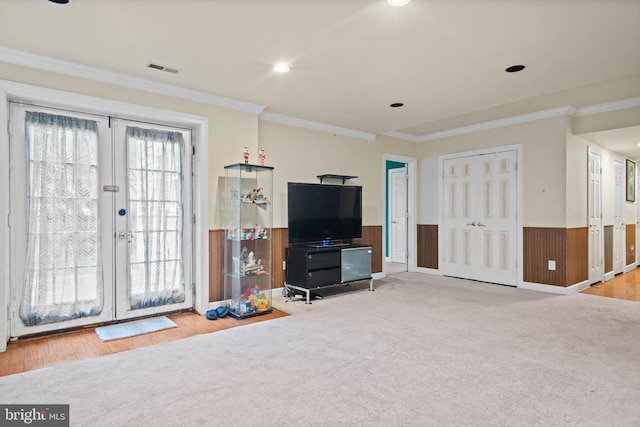 living room with ornamental molding, light hardwood / wood-style flooring, and french doors