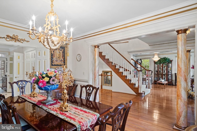 dining room with an inviting chandelier, wood-type flooring, decorative columns, and crown molding