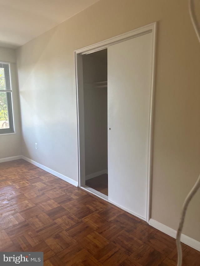 3601 Wisconsin Ave NW Unit 302, Washington, DC 20016 - unfurnished bedroom featuring a closet and baseboards