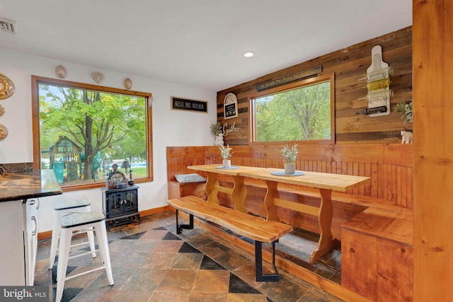 dining room featuring wood walls