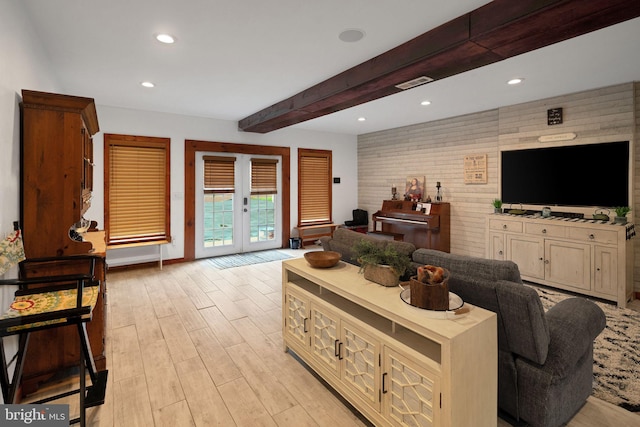 living room with french doors, light wood-type flooring, and beam ceiling