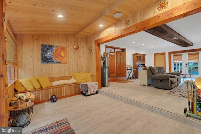 interior space featuring wood ceiling, light wood-type flooring, wood walls, and french doors