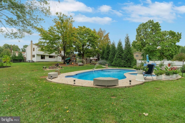 view of pool featuring a playground, a yard, and a patio area