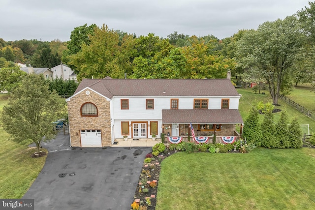 view of front of property with a garage and a front lawn