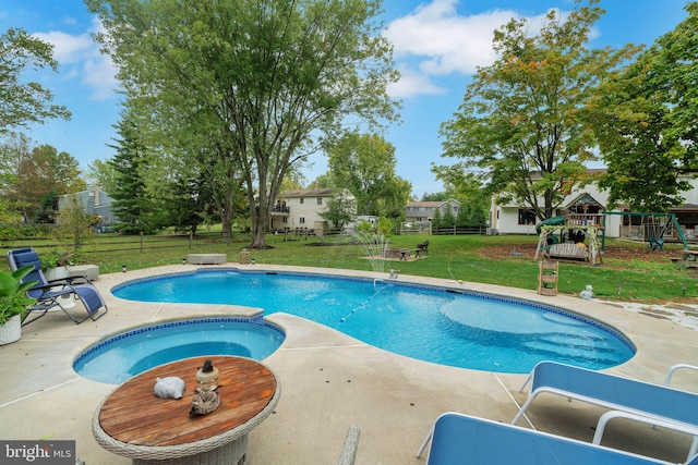 view of pool featuring a yard, an in ground hot tub, and a patio area