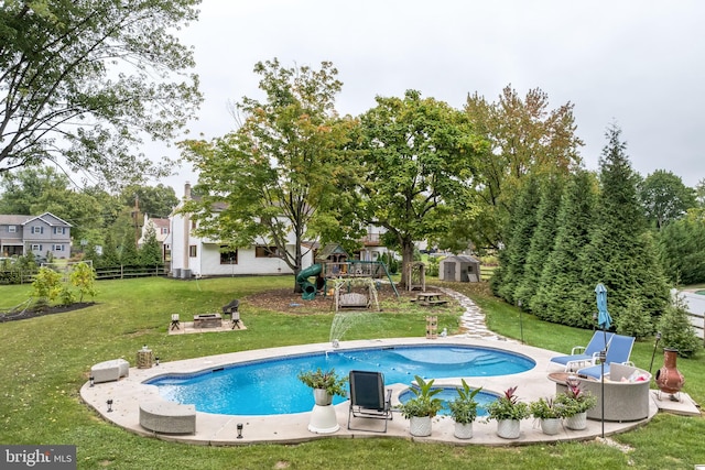 view of pool featuring a patio area and a yard