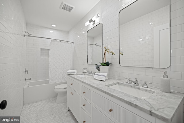 full bathroom with shower / tub combo, tasteful backsplash, vanity, tile walls, and toilet