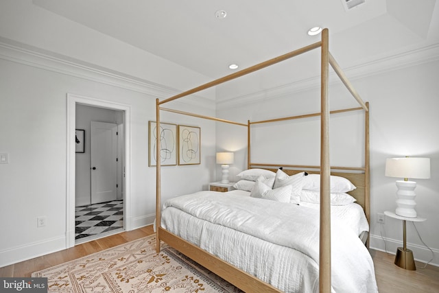 bedroom featuring hardwood / wood-style floors and ornamental molding