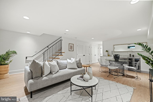 living room with wine cooler and light hardwood / wood-style flooring