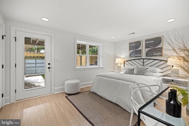 bedroom with access to outside and light hardwood / wood-style floors