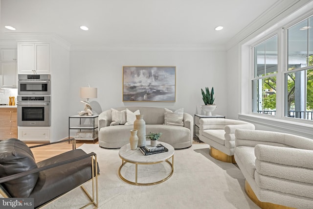 living room with light wood-type flooring and crown molding