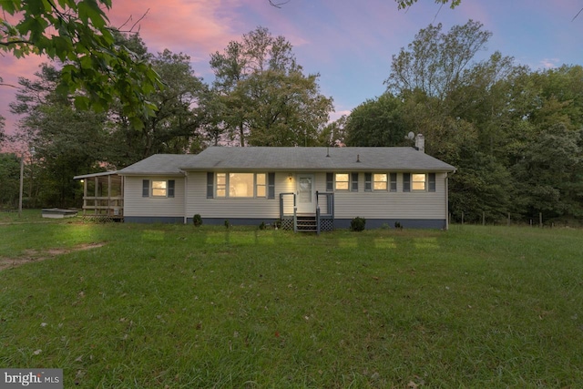 view of front of home featuring a lawn