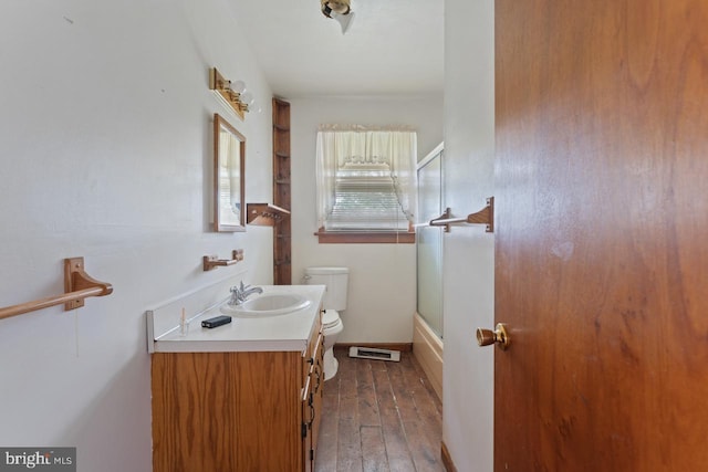 full bathroom with toilet, vanity, wood-type flooring, and shower / bath combination with glass door