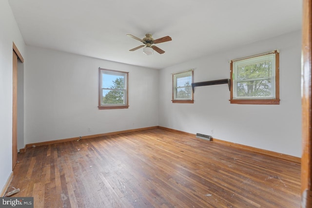 unfurnished room with hardwood / wood-style floors and ceiling fan