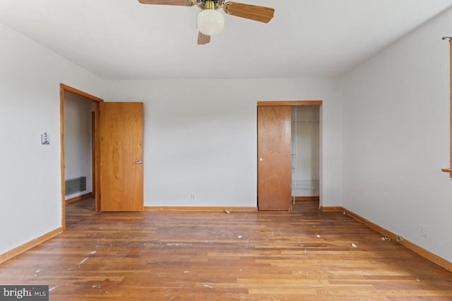 unfurnished bedroom featuring a closet, ceiling fan, and hardwood / wood-style floors