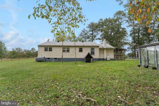 back of property featuring a yard