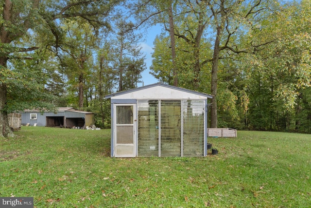 view of outbuilding with a lawn