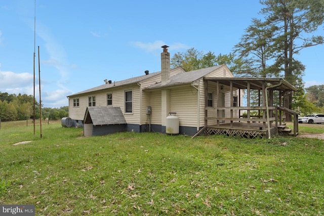 rear view of property with a yard