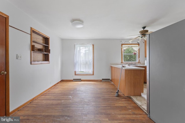 kitchen with ceiling fan and dark hardwood / wood-style flooring