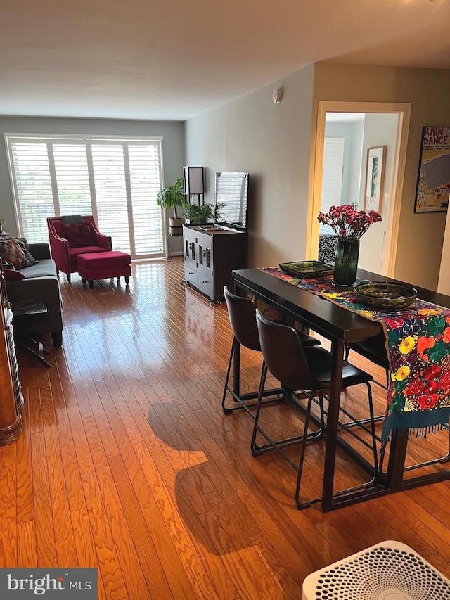 dining space with wood-type flooring