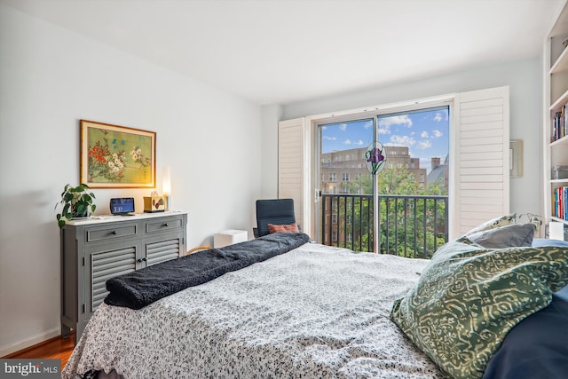 bedroom with dark hardwood / wood-style flooring and access to outside