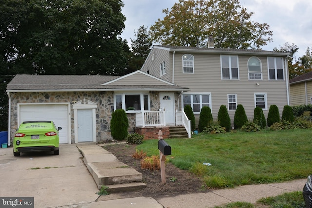 view of front of home with a front lawn and a garage