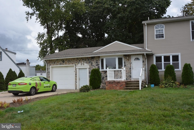 view of front facade with a garage and a front lawn