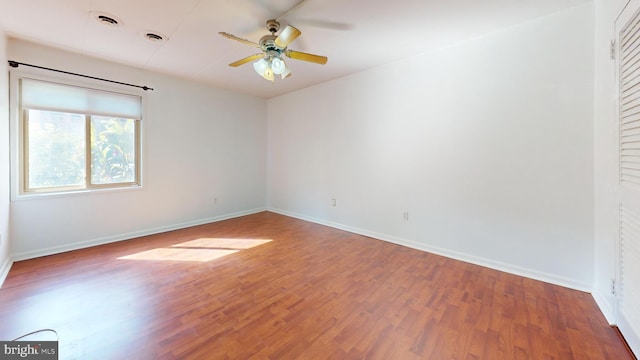 unfurnished room featuring ceiling fan and hardwood / wood-style floors