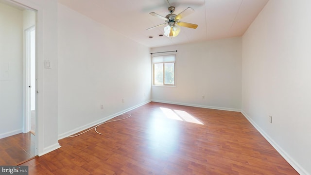 empty room featuring wood-type flooring and ceiling fan