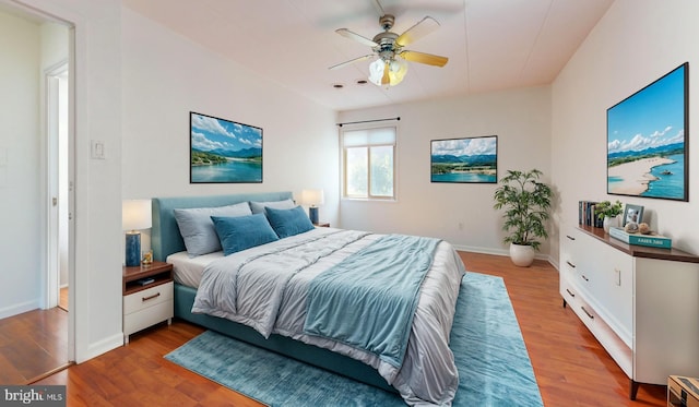 bedroom with light hardwood / wood-style floors and ceiling fan