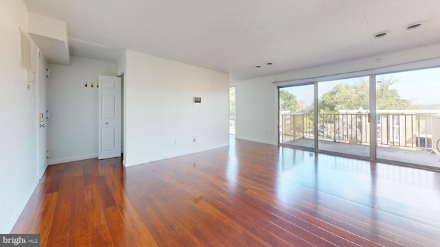 unfurnished room featuring dark hardwood / wood-style floors