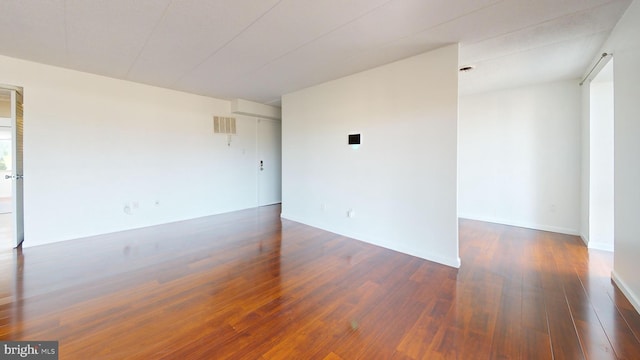 unfurnished room featuring dark hardwood / wood-style floors