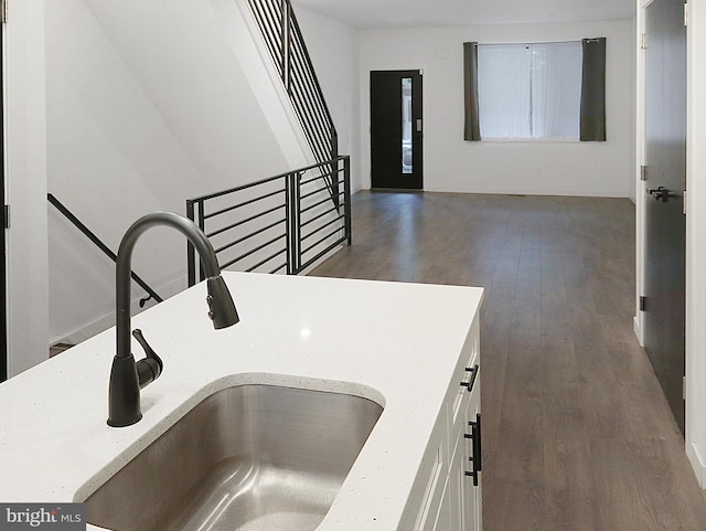 interior space featuring sink, dark wood-type flooring, and elevator