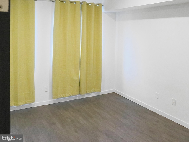 empty room with dark hardwood / wood-style floors