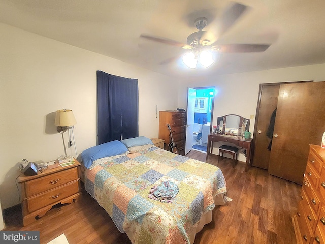 bedroom with ensuite bath, dark hardwood / wood-style flooring, and ceiling fan