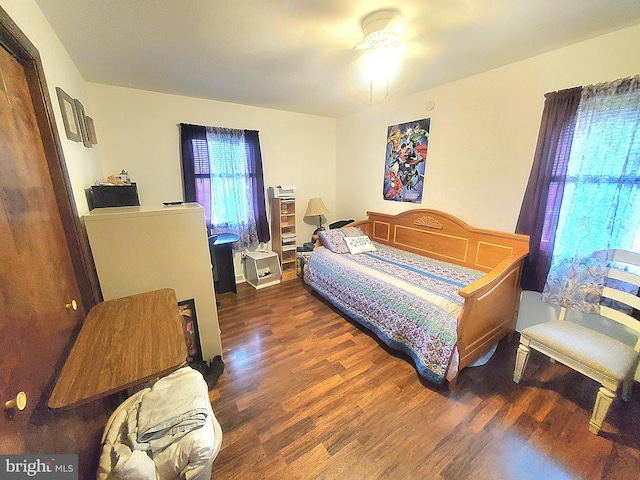 bedroom featuring ceiling fan and dark hardwood / wood-style floors