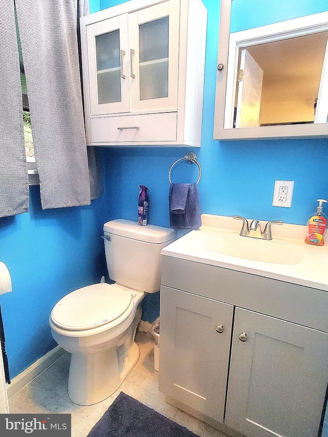 bathroom featuring vanity and toilet