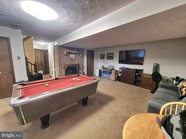 recreation room featuring a fireplace, light colored carpet, pool table, and a textured ceiling