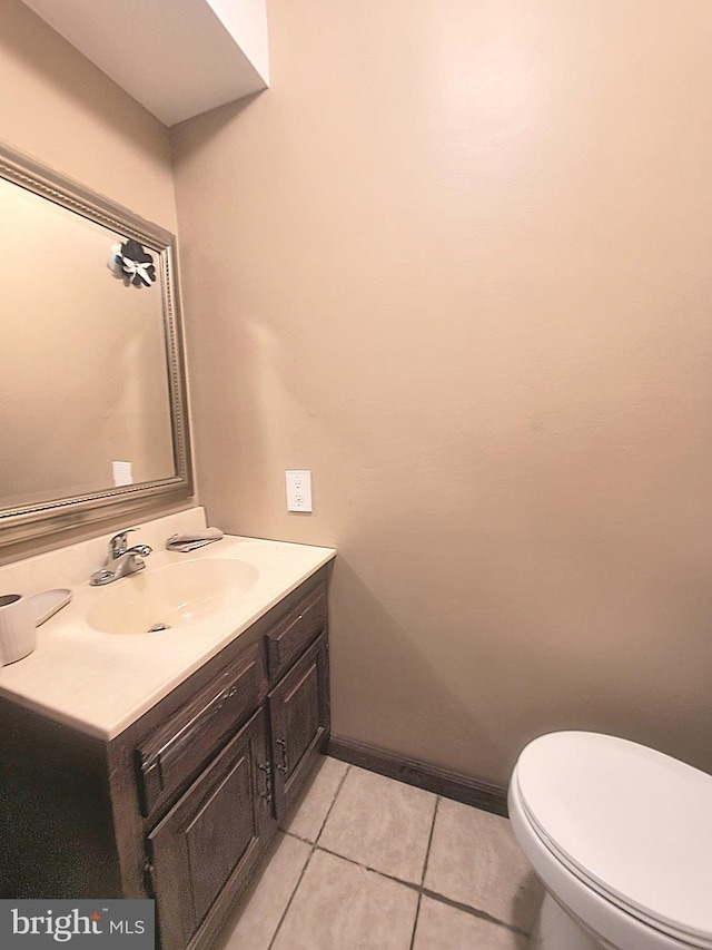 bathroom featuring tile patterned flooring, vanity, and toilet