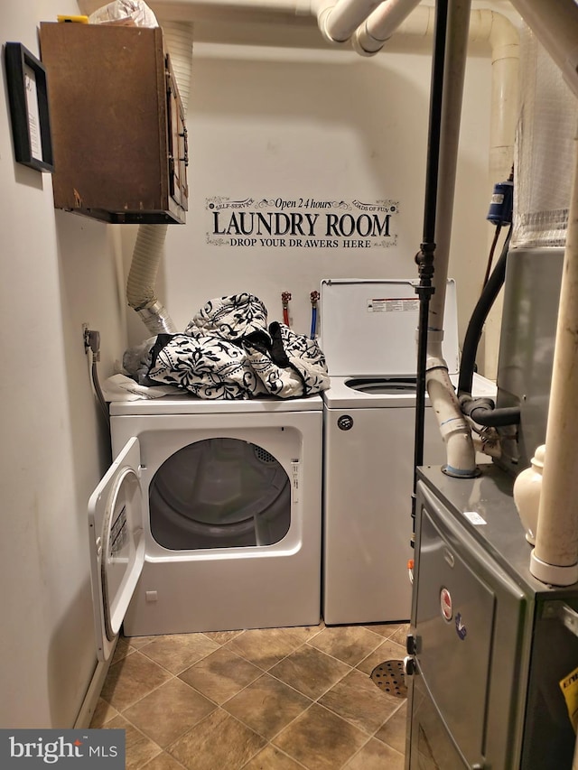 washroom featuring tile patterned flooring and washer and dryer